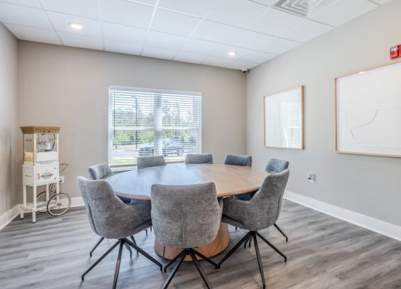 a conference room with a large table and chairs and a window