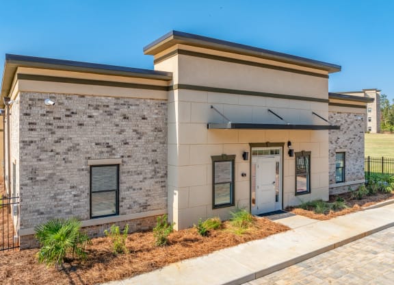 a building with a door and a sidewalk in front of it