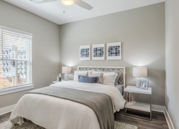 a bedroom with a bed and a ceiling fan