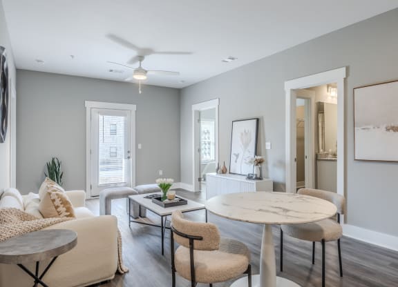 an open living room and dining room with furniture and a ceiling fan