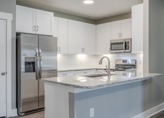 a kitchen with stainless steel appliances and a granite counter top