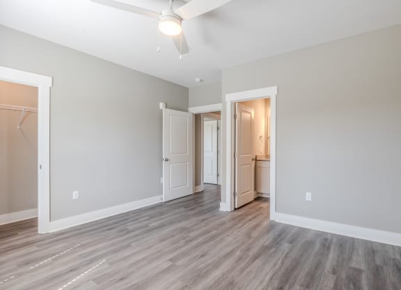 a renovated living room with grey walls and wood flooring