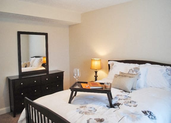a bedroom with a bed and a mirror