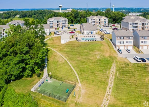 a city with a tennis court in front of houses