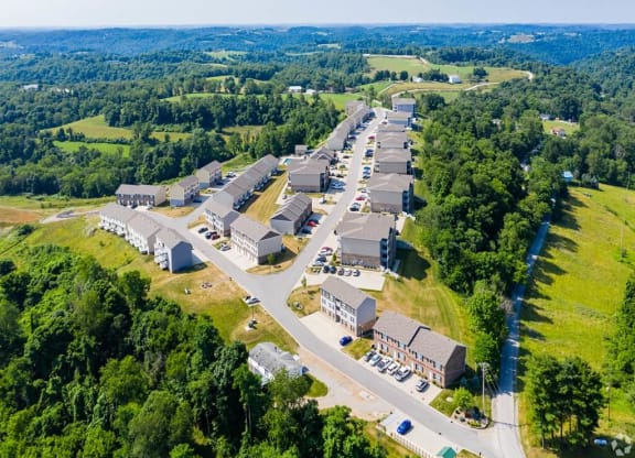 an aerial view of a village with buildings and a highway