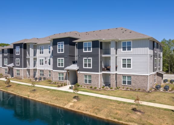 an aerial view of an apartment building next to a body of water