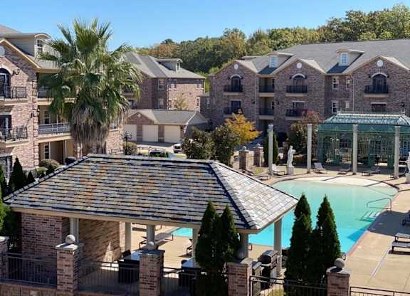 A large building with a pool in front.