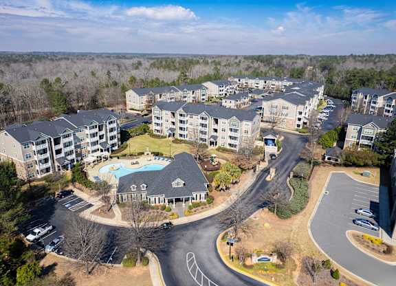 an aerial view of an apartment complex with a swimming pool