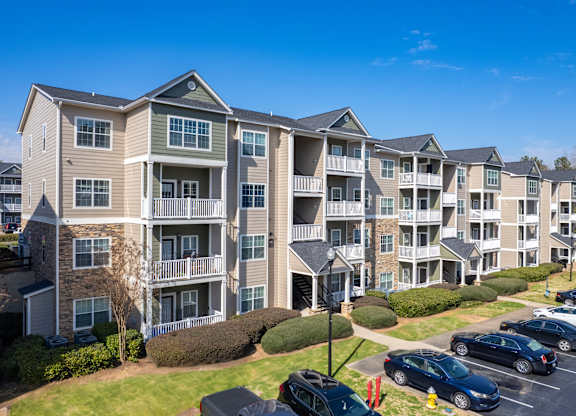 an apartment building with cars parked in front of it