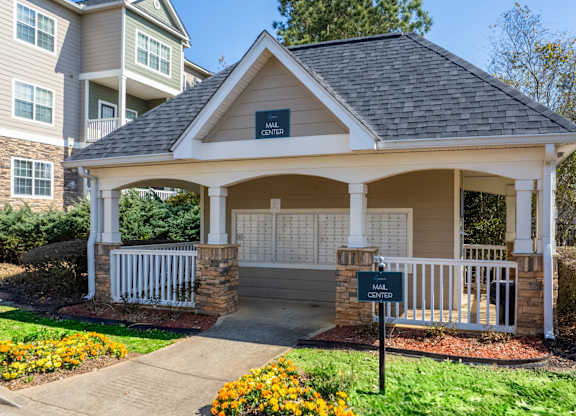 a small porch with a sign in front of a house