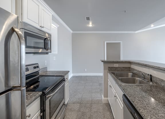a kitchen with granite counter tops and stainless steel appliances