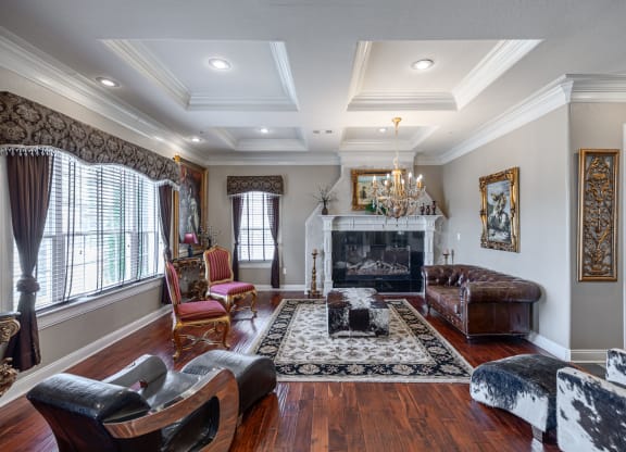 a living room with a fireplace and a couch and chairs