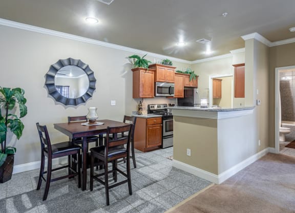 an open kitchen and dining area with a table and chairs