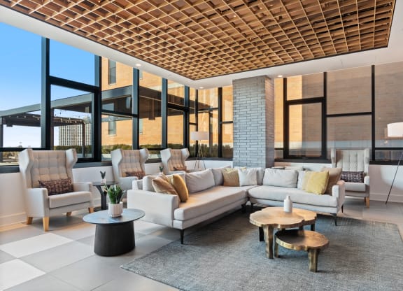 a living room with couches and chairs in front of a window