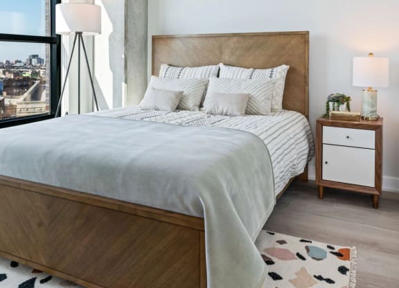 a bedroom with a large bed and a large window