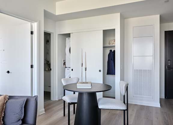 A modern dining room with a round table and chairs.