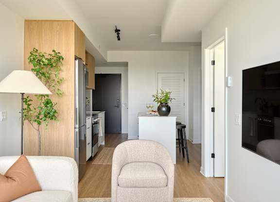 A living room with a white couch and a lamp.