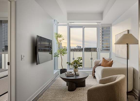 A living room with a flat screen TV mounted on the wall.