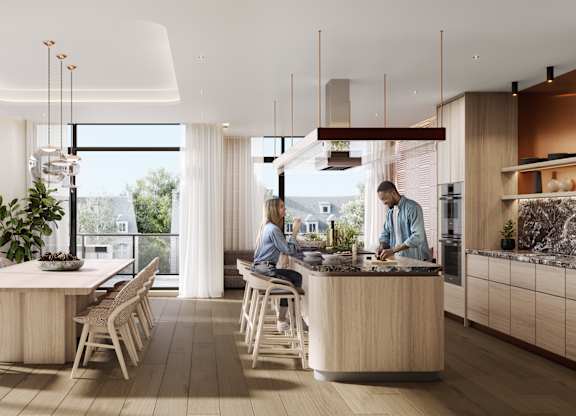 A modern kitchen with a dining table and chairs.