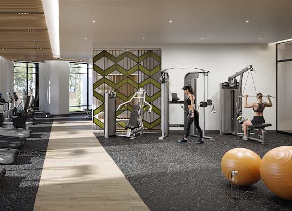 A gym with people working out and exercise equipment.