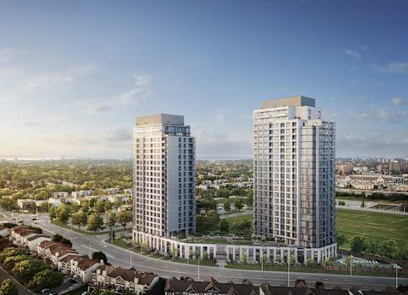 Two modern high-rise buildings are situated in a green, tree-filled urban area.