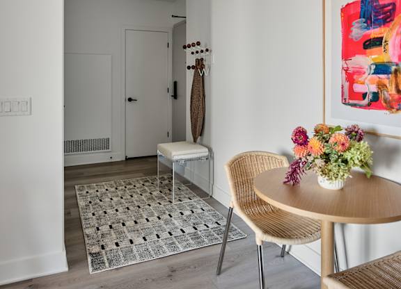 A modern dining room with a round table and chairs.