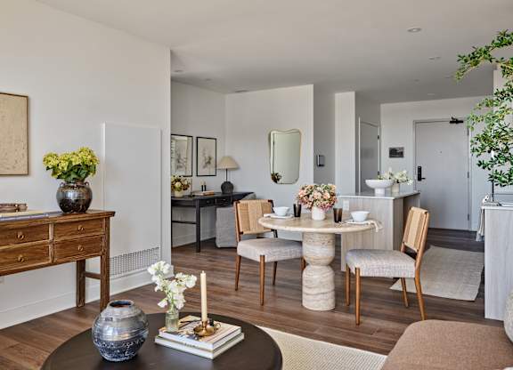 A dining room with a round table and chairs.