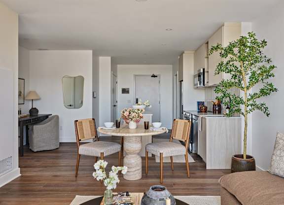A living room with a dining table and chairs.