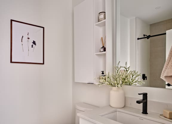 A white toilet sits next to a sink in a bathroom.