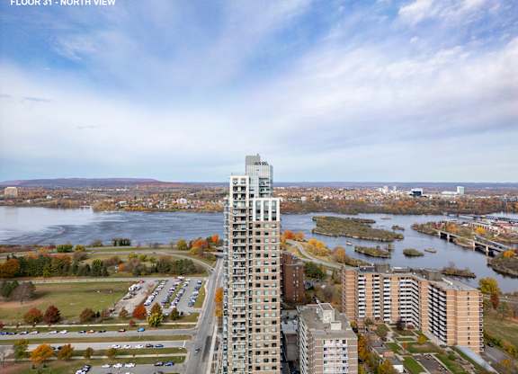an aerial view of a city with tall buildings and a river