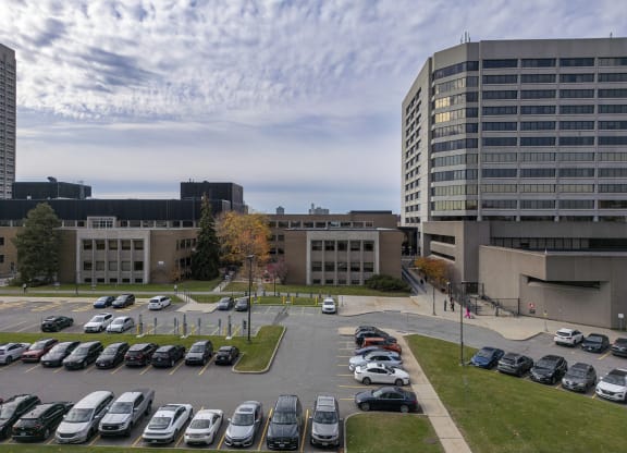 a parking lot in front of a building with cars parked
