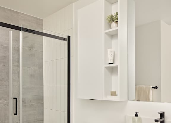 A white toilet sits next to a sink in a modern bathroom.