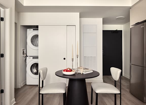 A modern kitchen with a table set for two.