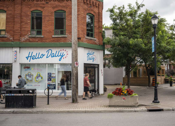 people walking down a street in front of a store