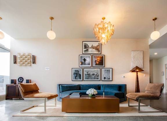 A living room with a blue couch and a coffee table.