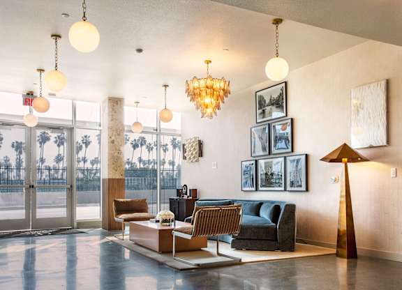 A living room with a couch, chairs, and a coffee table.