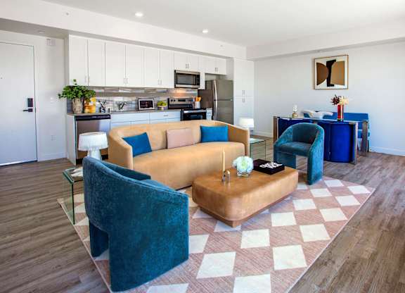 A living room with a brown couch and blue chairs.