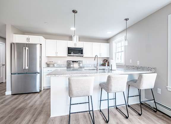 Modern kitchen with granite island and bar seating at Windham Village Apartments, Windham