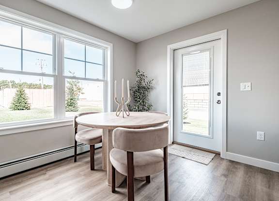 Dining area with round table and large windows at Windham Village Apartments, Windham, ME 04062