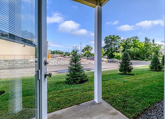 Open patio doors with lawn and parking view at Windham Village Apartments, Windham, 04062