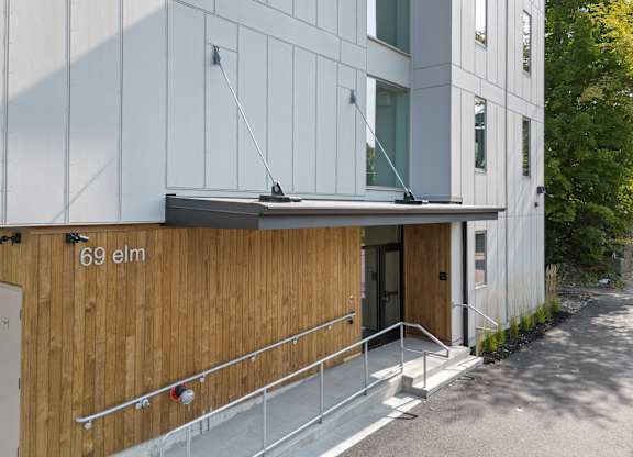 the side of a building with a wooden wall and stairs