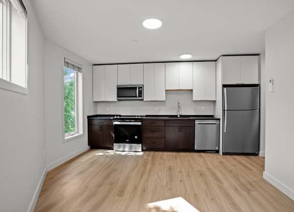 a kitchen with white cabinets and a stainless steel refrigerator