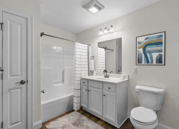 Bathroom with white vanity and tub shower combo at Autumn Woods Apartments, Westbrook, ME