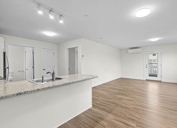 Open concept living area with kitchen island at Autumn Woods Apartments, Maine, 04092
