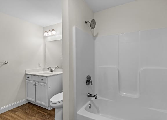 Modern bathroom with white vanity and shower at Autumn Woods Apartments, Westbrook