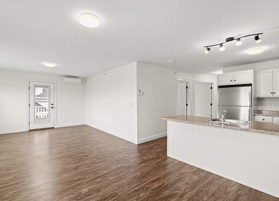 A kitchen area with a counter and cabinets.