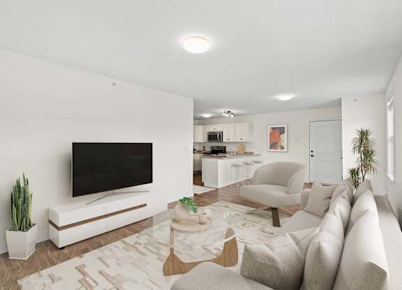 A modern living room with a large television and comfortable seating.