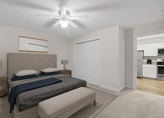 a bedroom with a bed and a ceiling fan