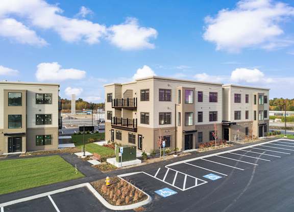 Blue skies, manicured grounds, and modern living—The Parker welcomes you home.