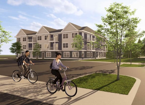 Two people riding bicycles in front of a large building.